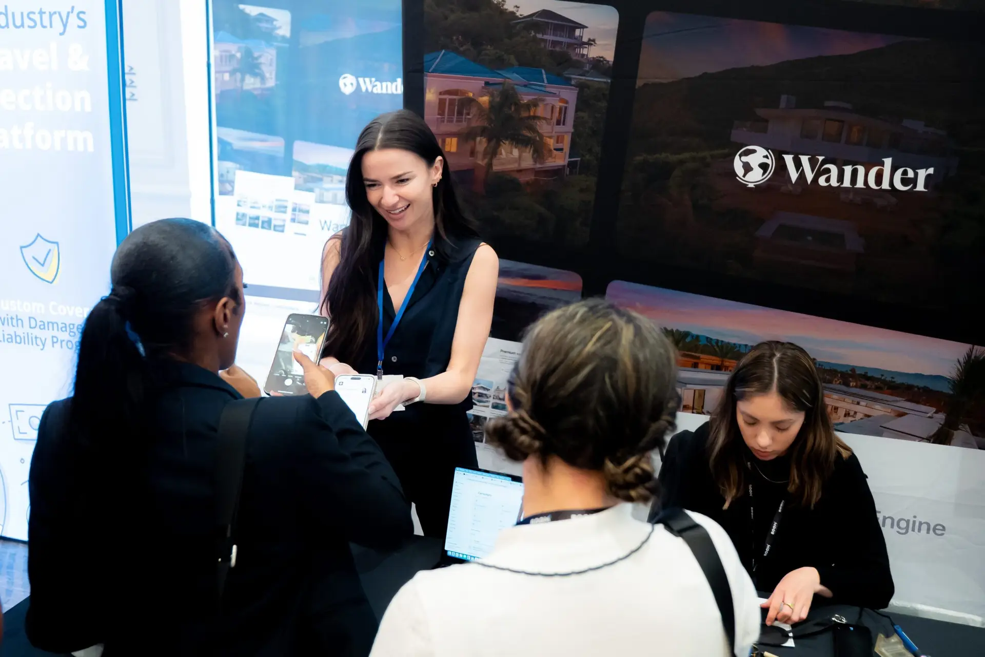 Business professionals connecting at the Wander exhibition booth during a corporate conference