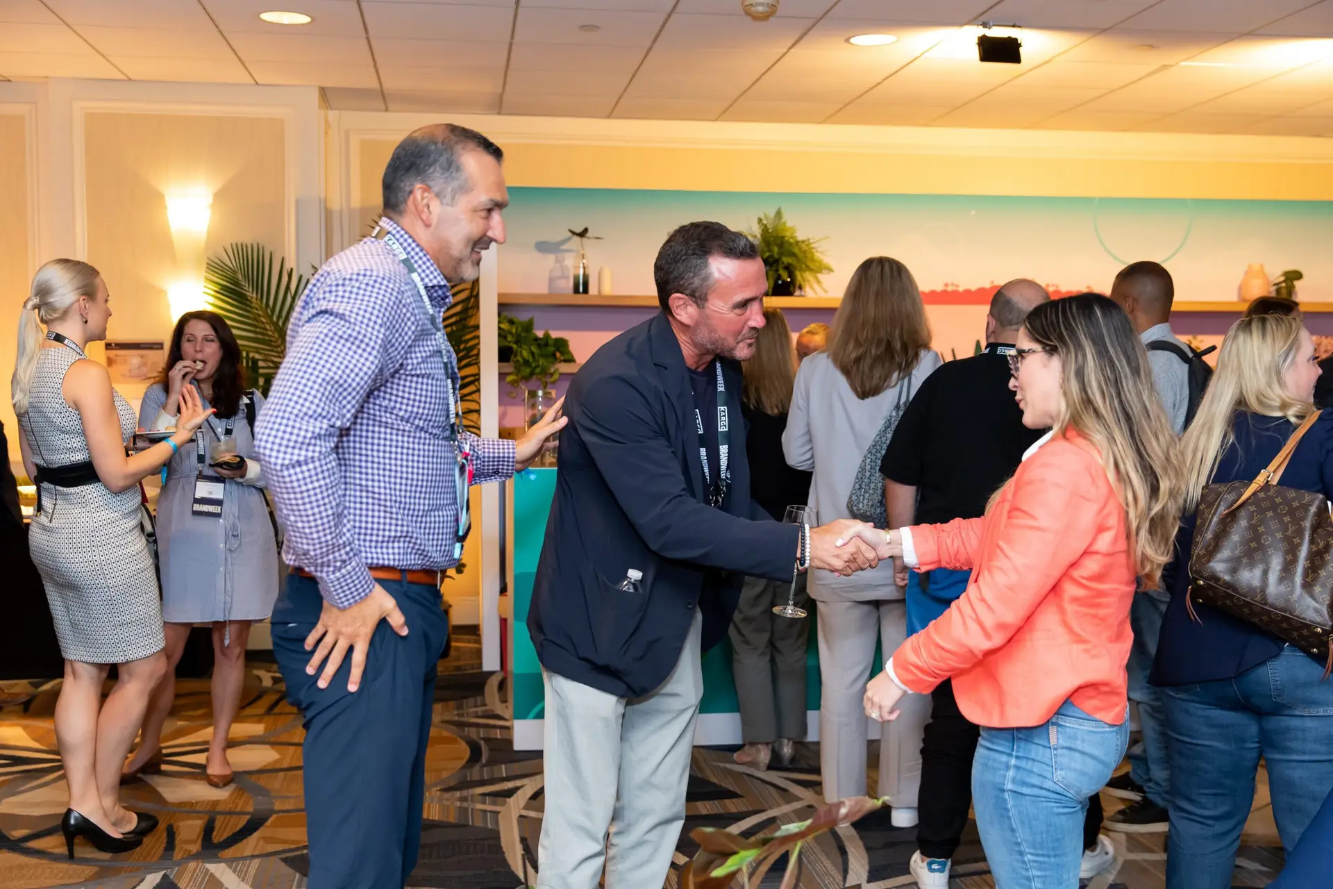 Candid photo of conference attendees Shaking hands during a break in Downtown Miami