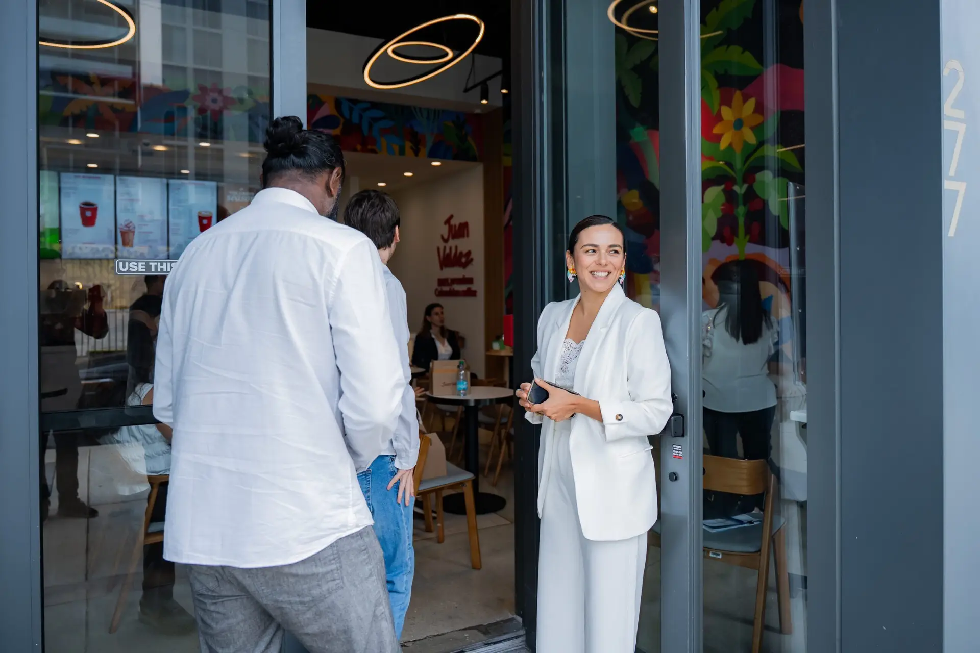Candid photography of Latin American CEOs networking inside Juan Valdez Wynwood - Miami Event Photographer