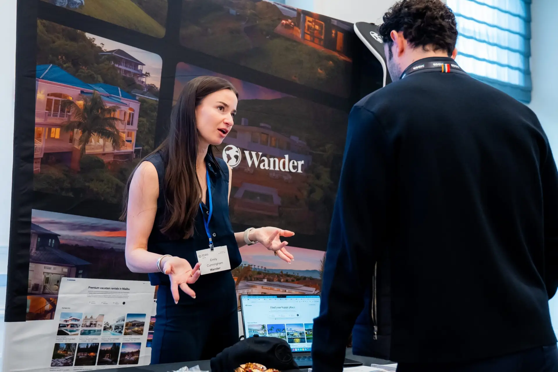 Corporate event photography of the Wander booth at a short-term rental industry conference in Aventura