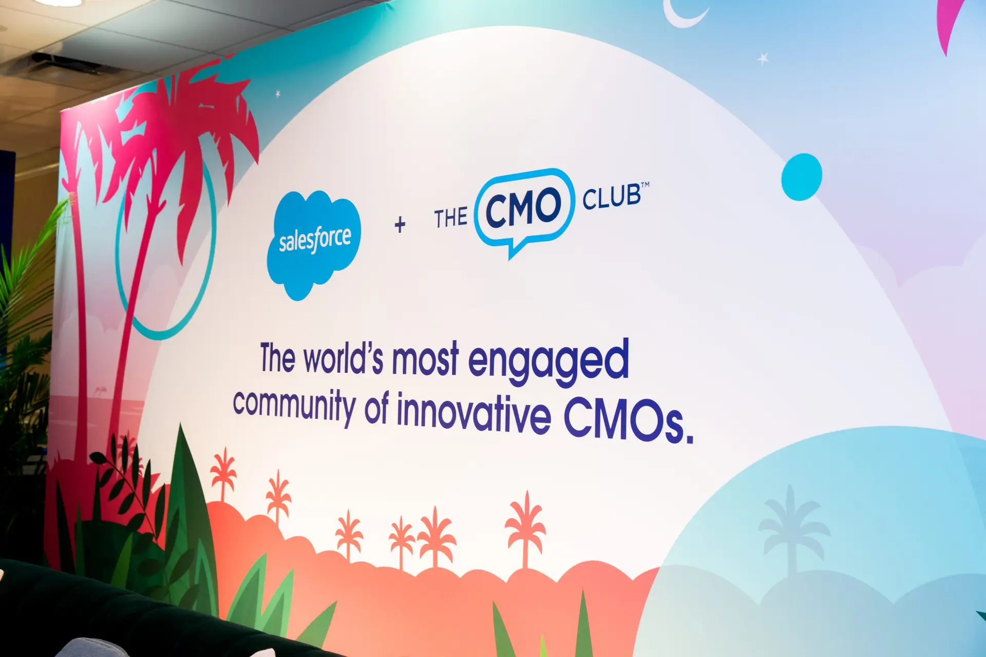 Custom Salesforce and CMO Club event branding display inside the venue