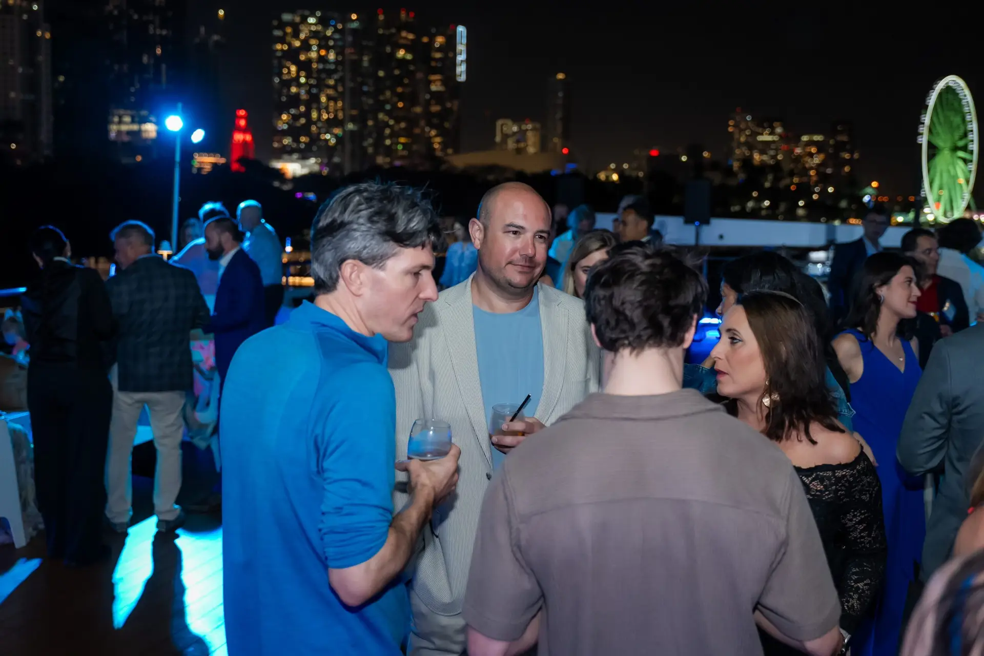 Guests networking on the upper deck of SeaFair Miami during a corporate event reception